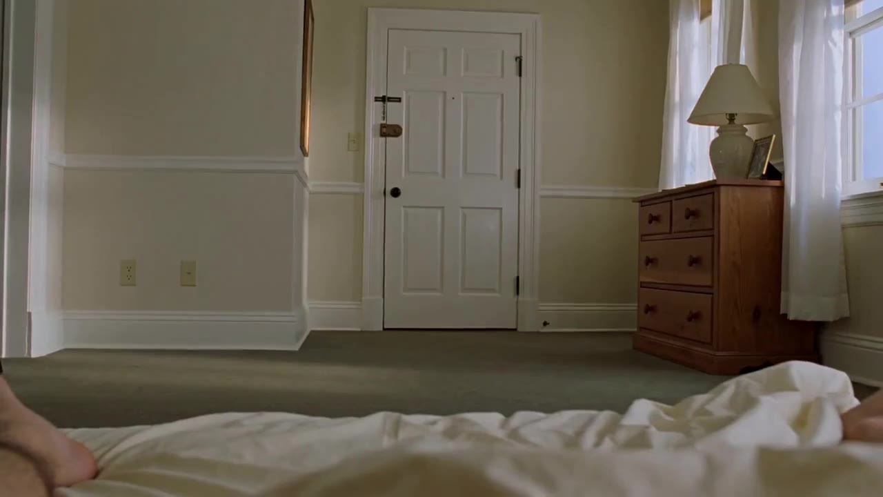 AI video of a white bedroom door seen from the foot of the bed
